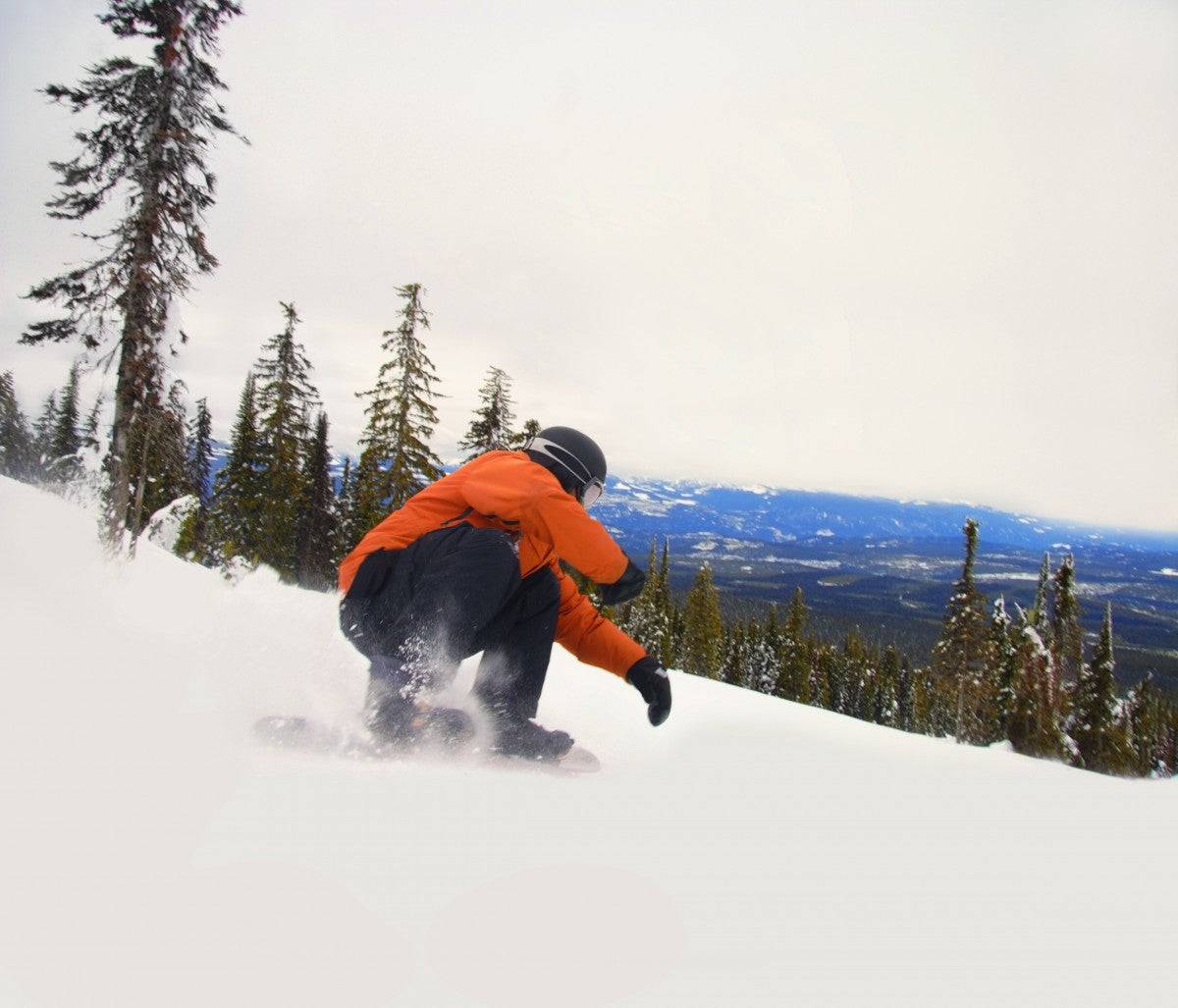 Snowboarder Crouching Down Low - Powderaddicts