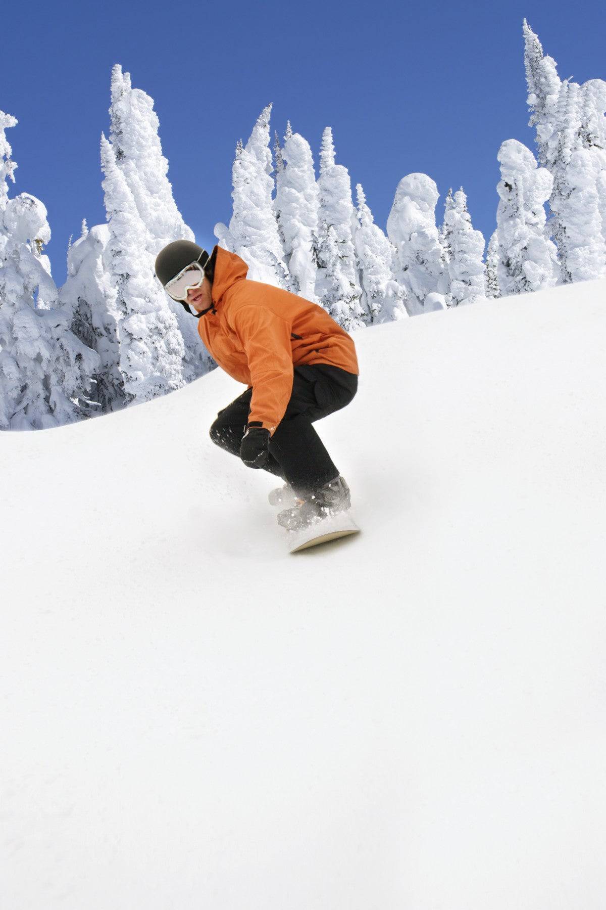 Snowboarder Going Down Snowy Hill - Powderaddicts