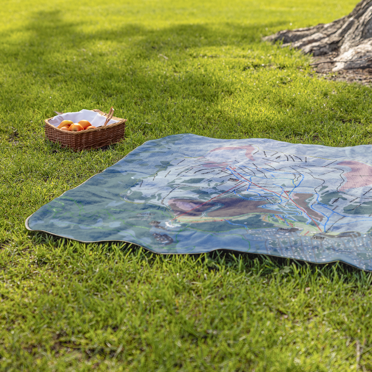 Alyeska_StadiumBlanket_Lifestyle_Grass_V_AS_Mockup.png