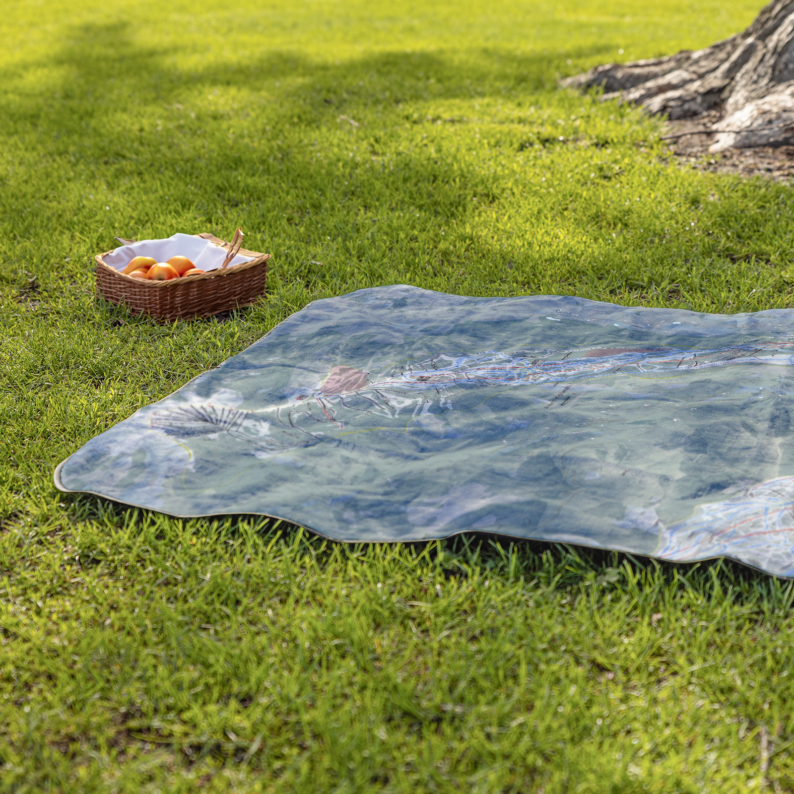 AspenHighlands_StadiumBlanket_Lifestyle_Grass_V_AS_Mockup.png