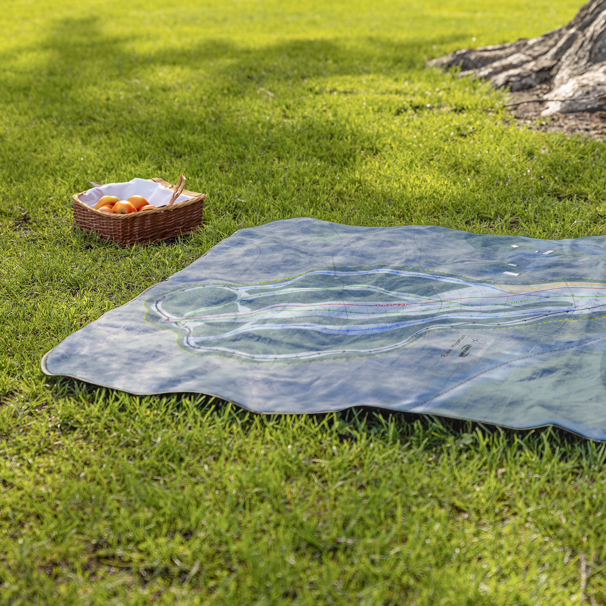 Baker_Mountain_StadiumBlanket_Lifestyle_Grass_V_AS_Mockup.png