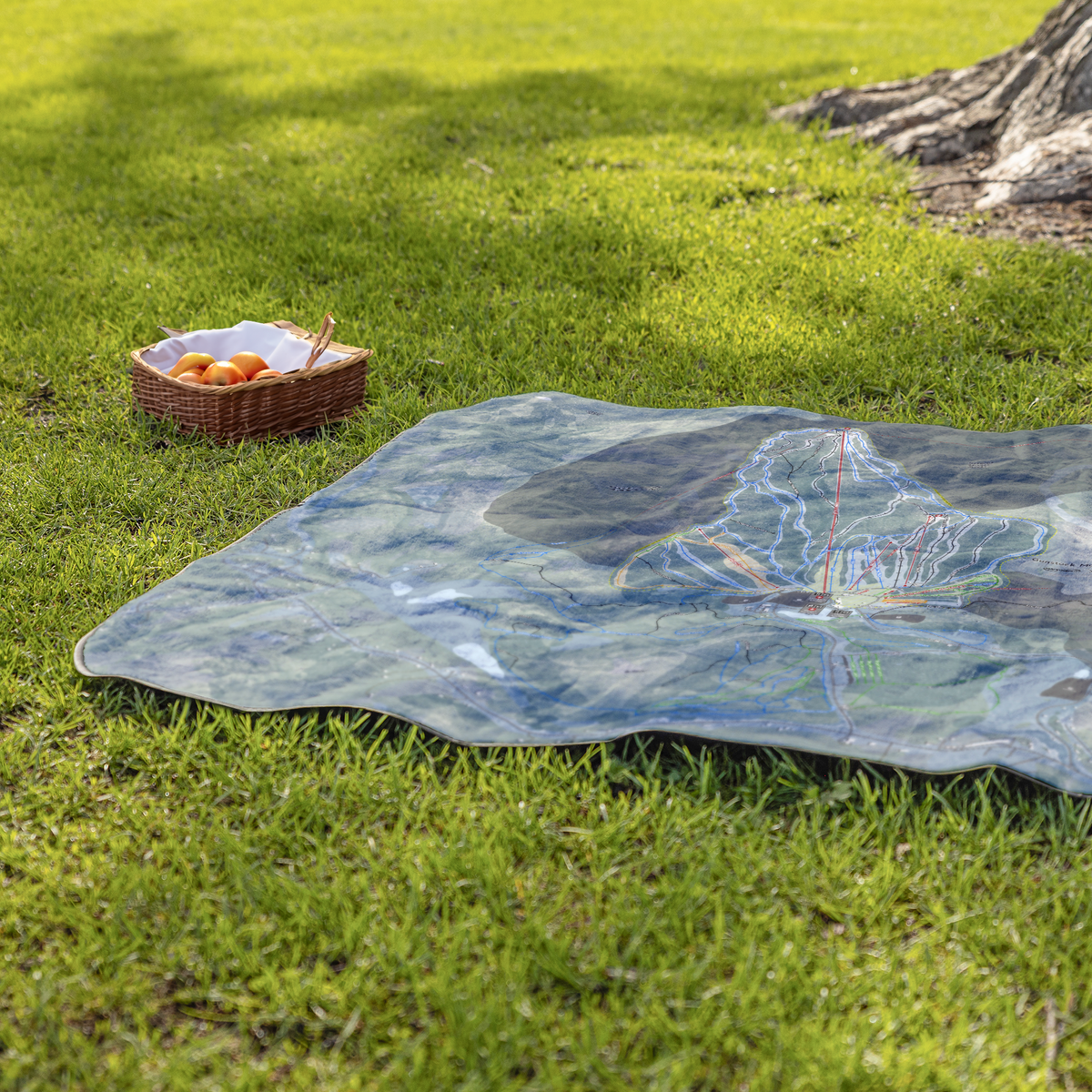 GunstockMountain_StadiumBlanket_Lifestyle_Grass_V_AS_Mockup.png
