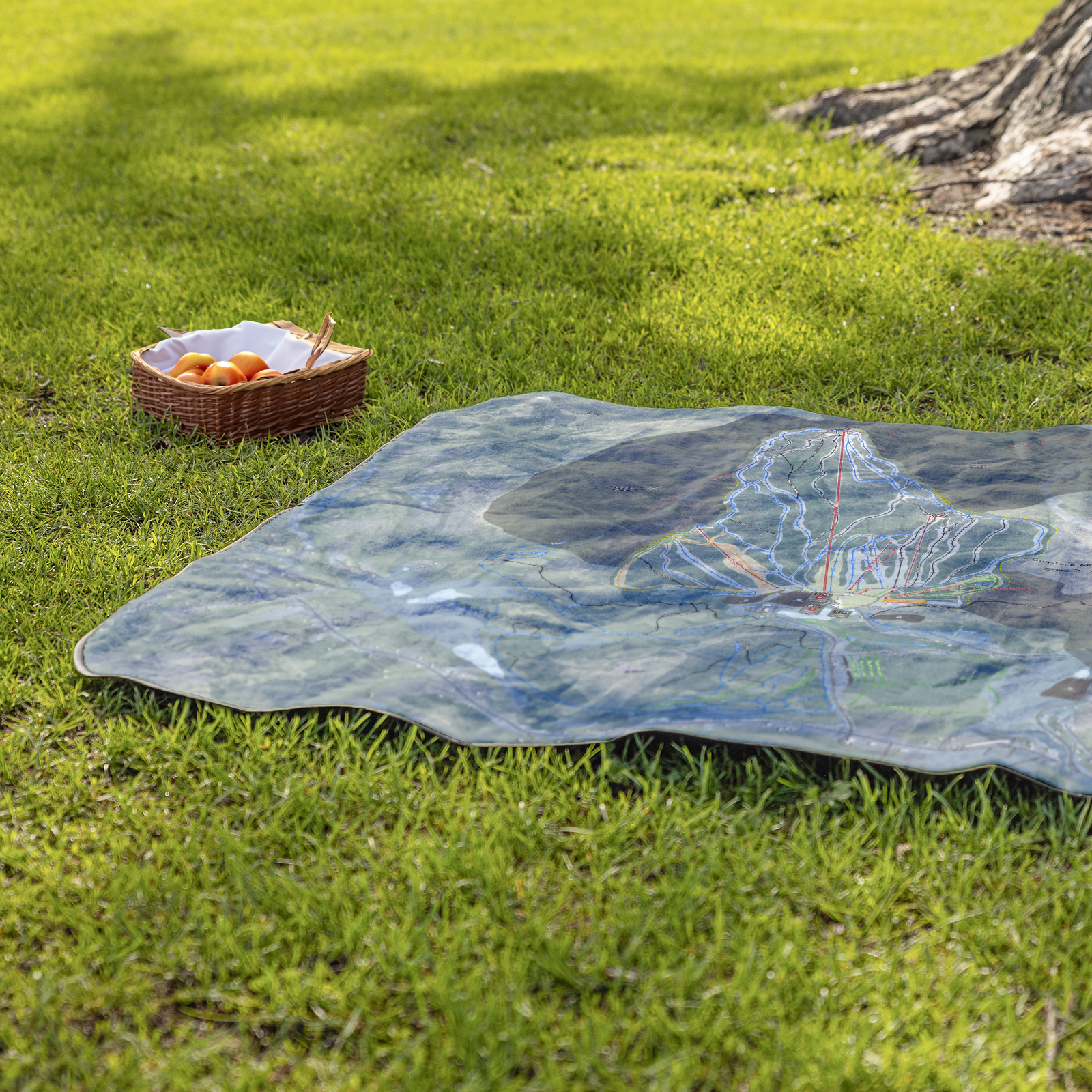 GunstockMountain_StadiumBlanket_Lifestyle_Grass_V_AS_Mockup.png
