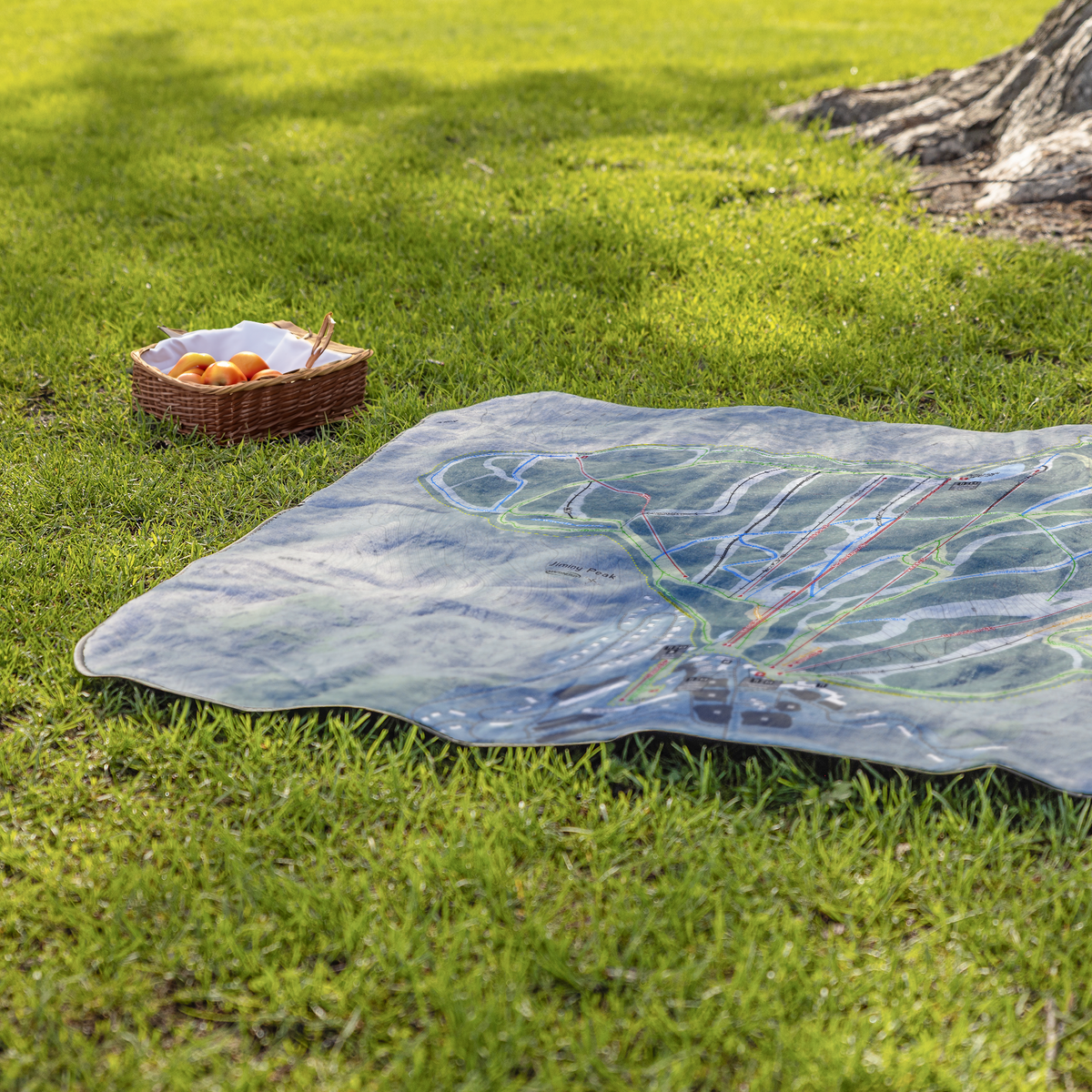 Jiminy_Peak_StadiumBlanket_Lifestyle_Grass_V_AS_Mockup.png