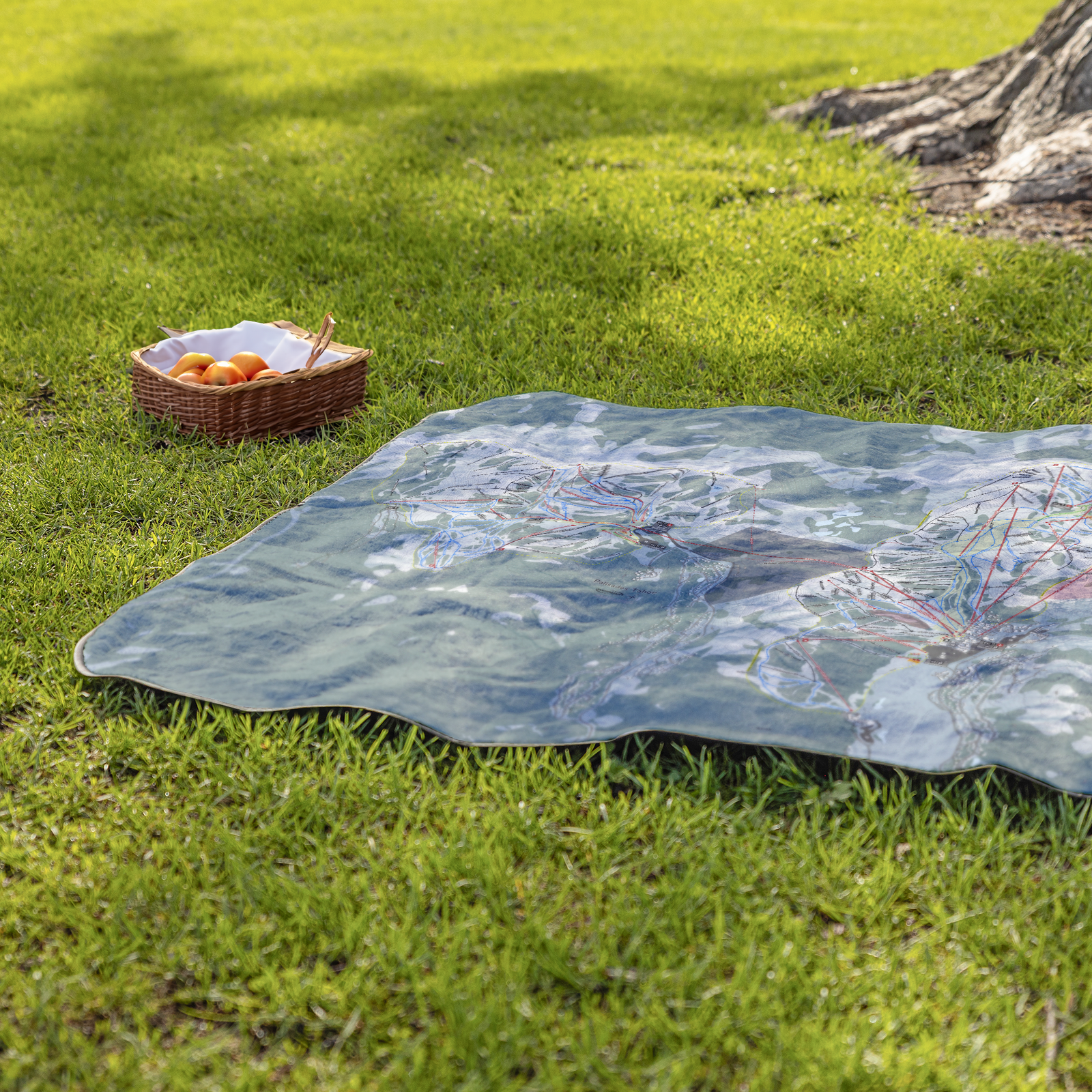 PalisadesTahoe_StadiumBlanket_Lifestyle_Grass_V_AS_Mockup.png