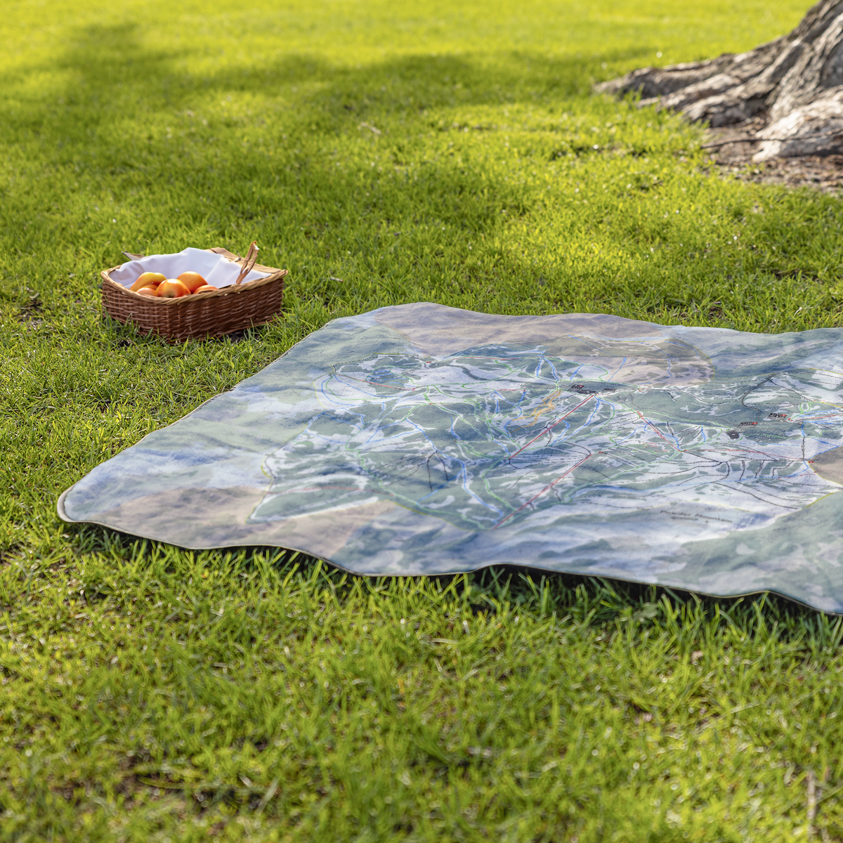 PowderMountain_StadiumBlanket_Lifestyle_Grass_V_AS_Mockup.png