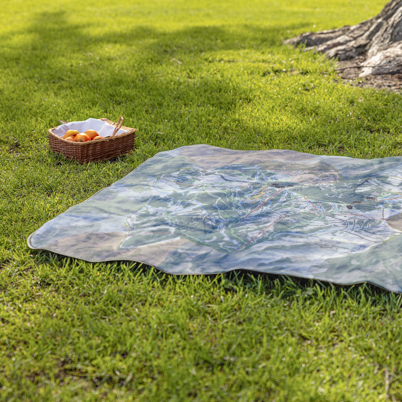 PowderMountain_StadiumBlanket_Lifestyle_Grass_V_AS_Mockup.png