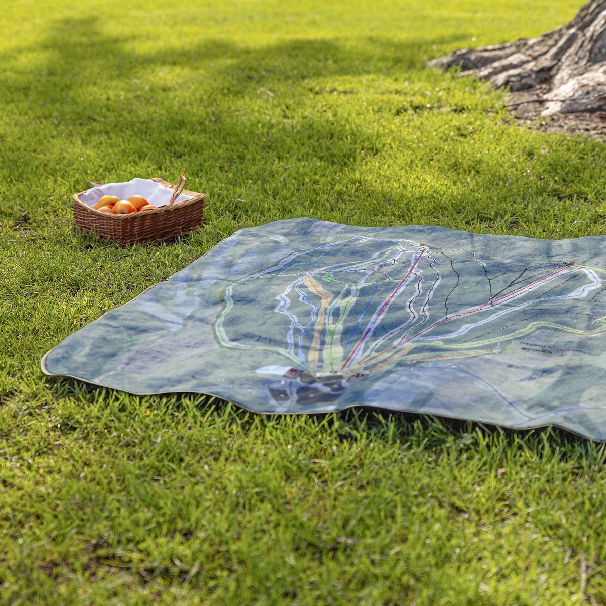 RaggedMountain_StadiumBlanket_Lifestyle_Grass_V_AS_Mockup.png