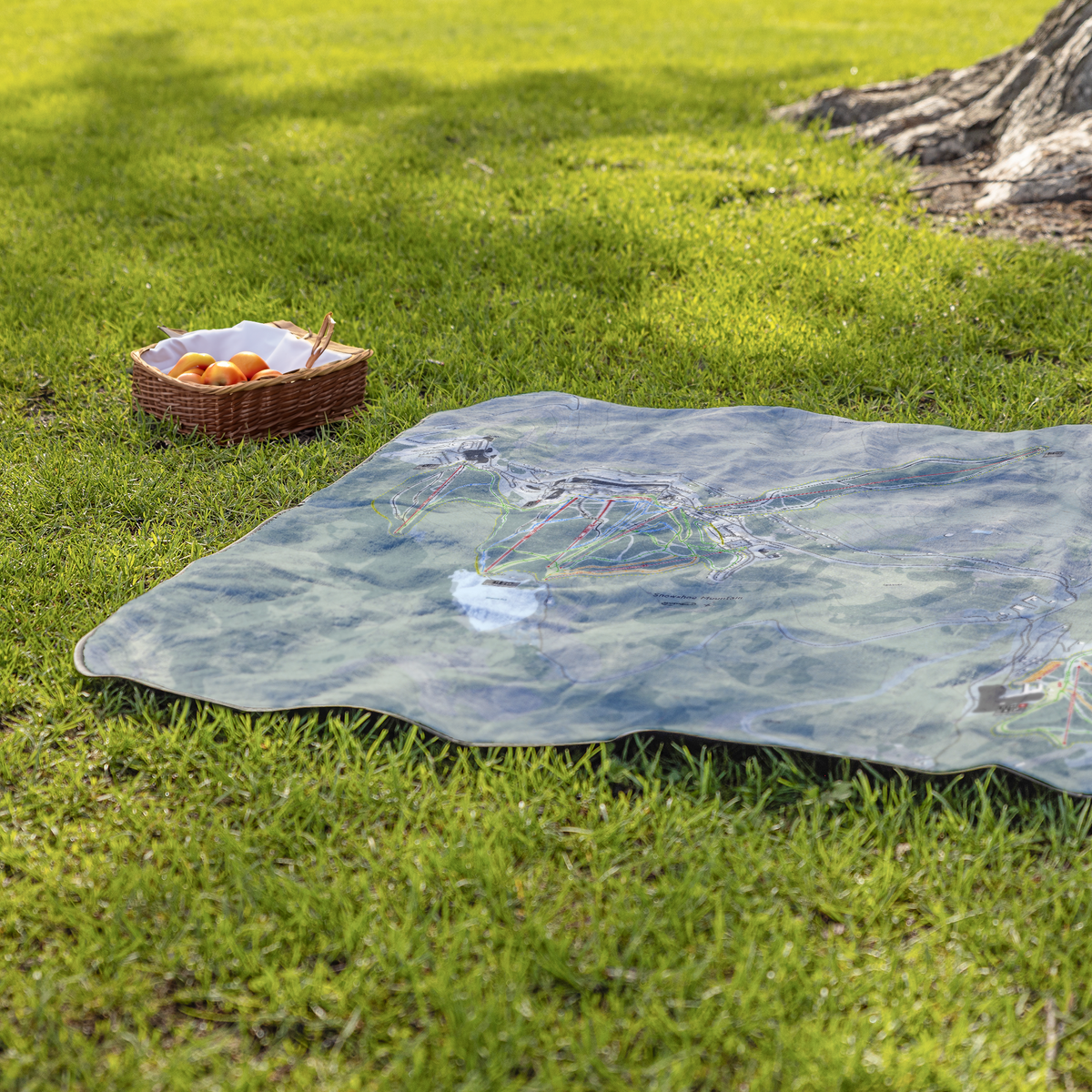 Snowshoe_Mountain_StadiumBlanket_Lifestyle_Grass_V_AS_Mockup.png