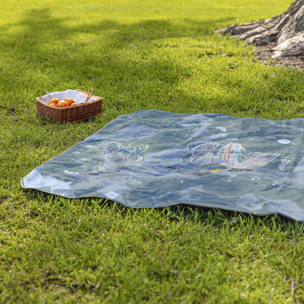 Summit_At_Snoqualmie_StadiumBlanket_Lifestyle_Grass_V_AS_Mockup.png