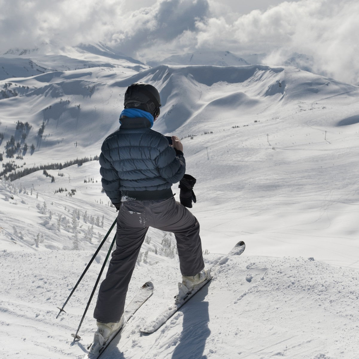 A Skier Pauses On The Trail To Look Out Over The Mountains; Whistler, British Columbia, Canada - Powderaddicts