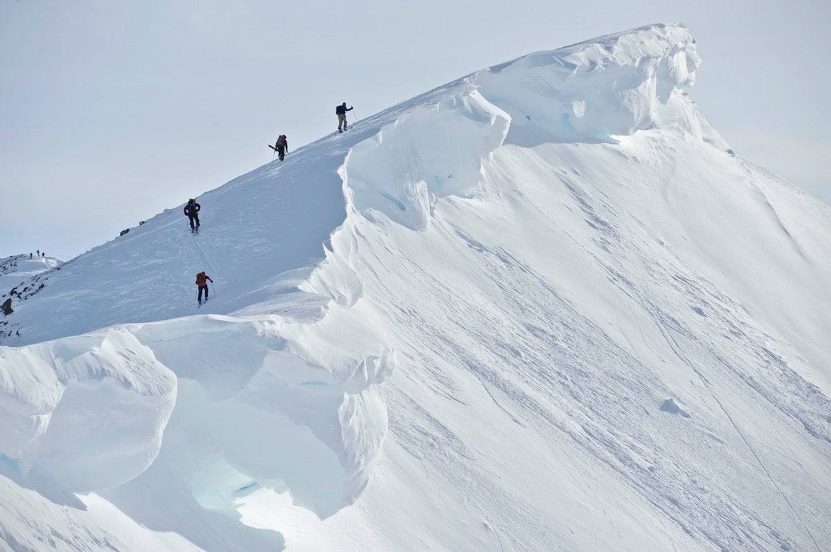 Backcountry Skiers On The Ridge Of Pms Bowl - Powderaddicts