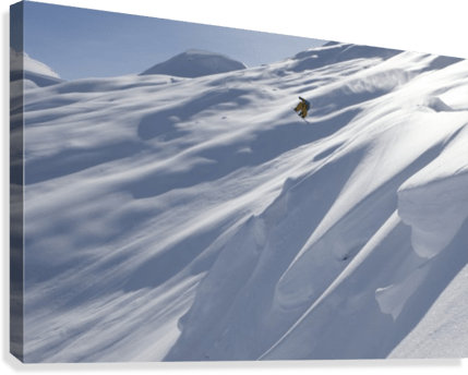 Professional snowboarder, Frederik Kalbermatten, heli boarding in the mountains above Haines - Powderaddicts