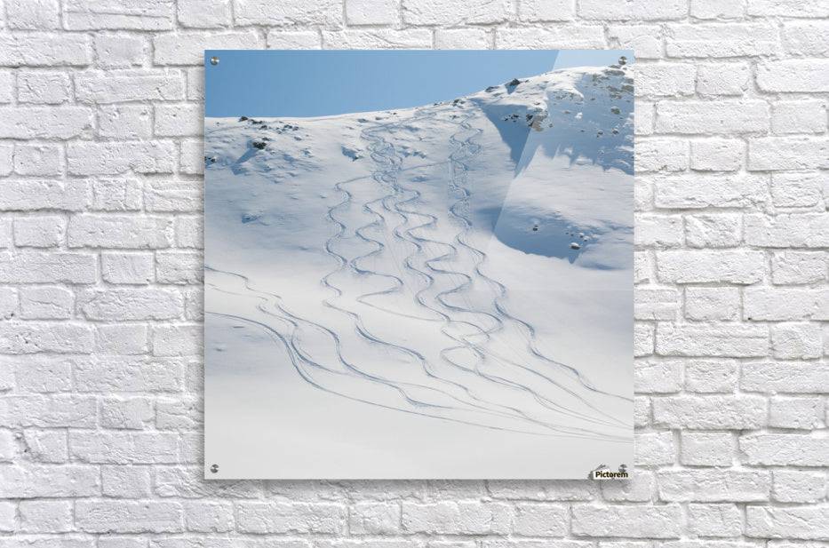 Ski tracks in the snow on a mountain - Powderaddicts