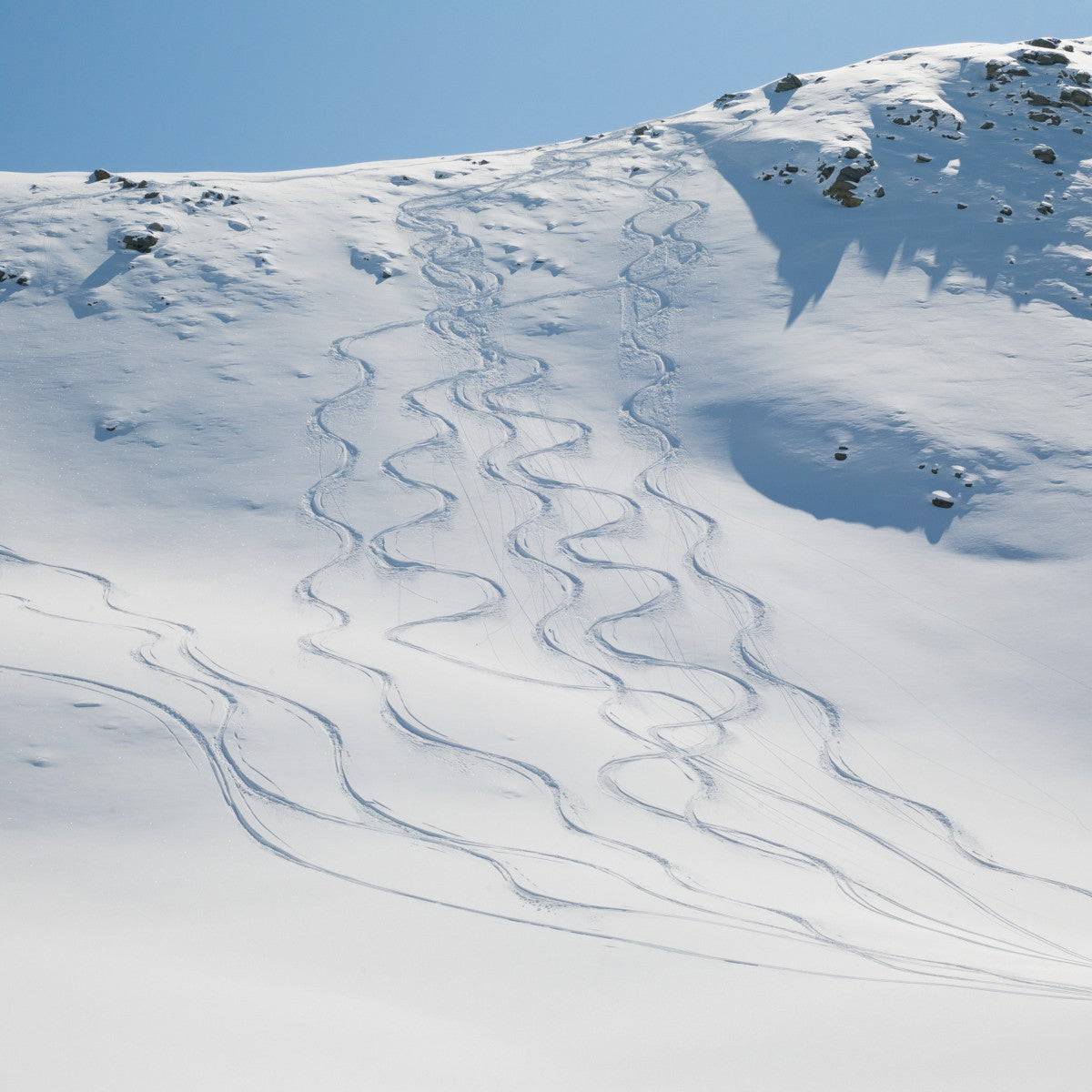 Ski tracks in the snow on a mountain - Powderaddicts