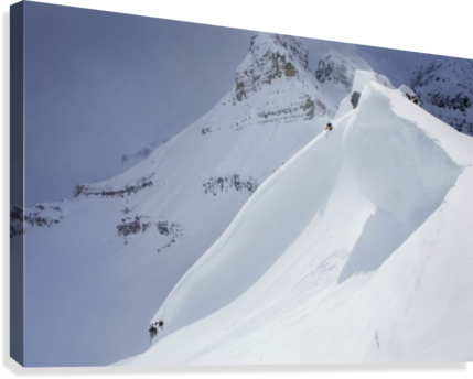 Skier On Crest Of Big Drop, Dwarfed By Mountain; Canada, British Columbia, Icefall Lodge - Powderaddicts