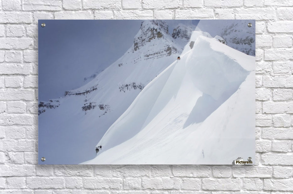 Skier On Crest Of Big Drop, Dwarfed By Mountain; Canada, British Columbia, Icefall Lodge - Powderaddicts
