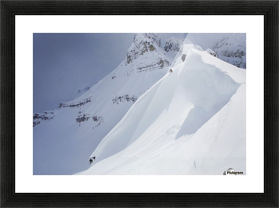 Skier On Crest Of Big Drop, Dwarfed By Mountain; Canada, British Columbia, Icefall Lodge - Powderaddicts