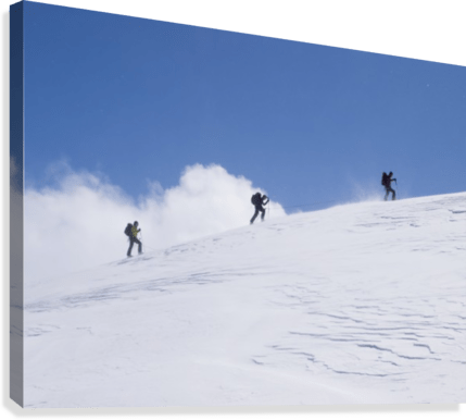 Three ski tourists walking to the summit - Powderaddicts