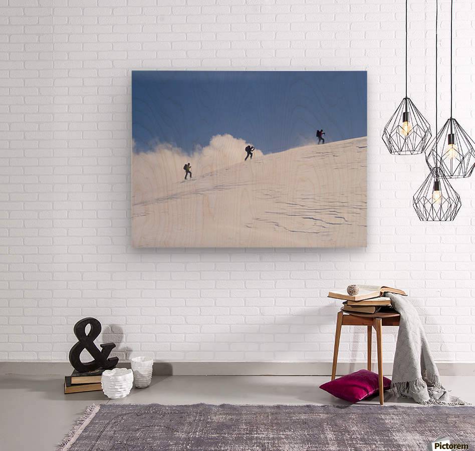 Three ski tourists walking to the summit - Powderaddicts