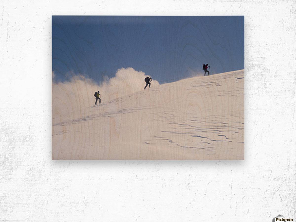 Three ski tourists walking to the summit - Powderaddicts