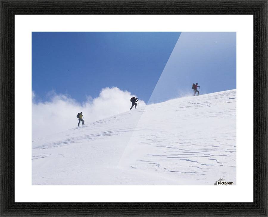 Three ski tourists walking to the summit - Powderaddicts