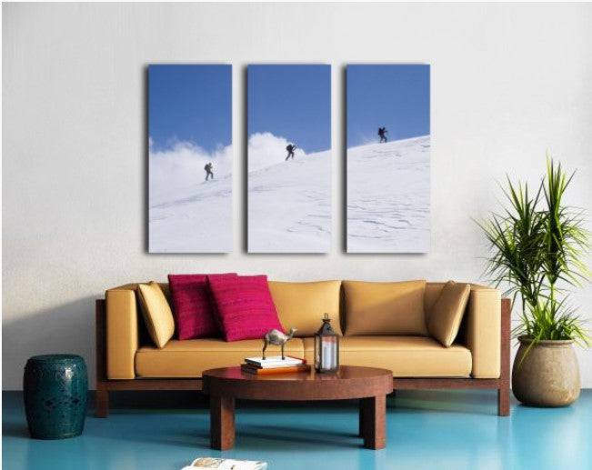 Three ski tourists walking to the summit - Powderaddicts