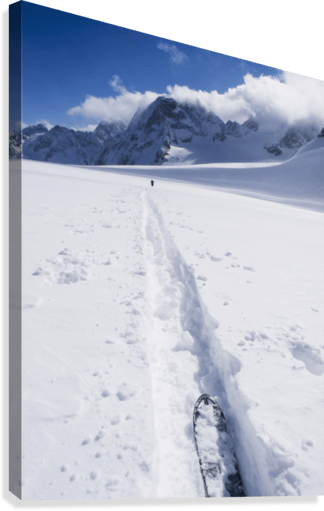 Two distant skiers ski touring across the Ottemma glacier, with skinning tracks - Powderaddicts