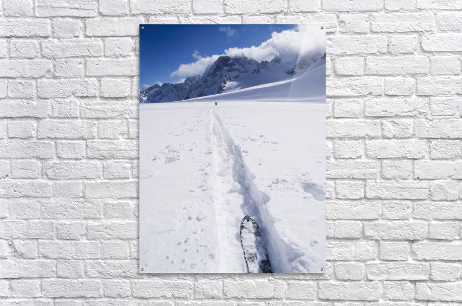 Two distant skiers ski touring across the Ottemma glacier, with skinning tracks - Powderaddicts