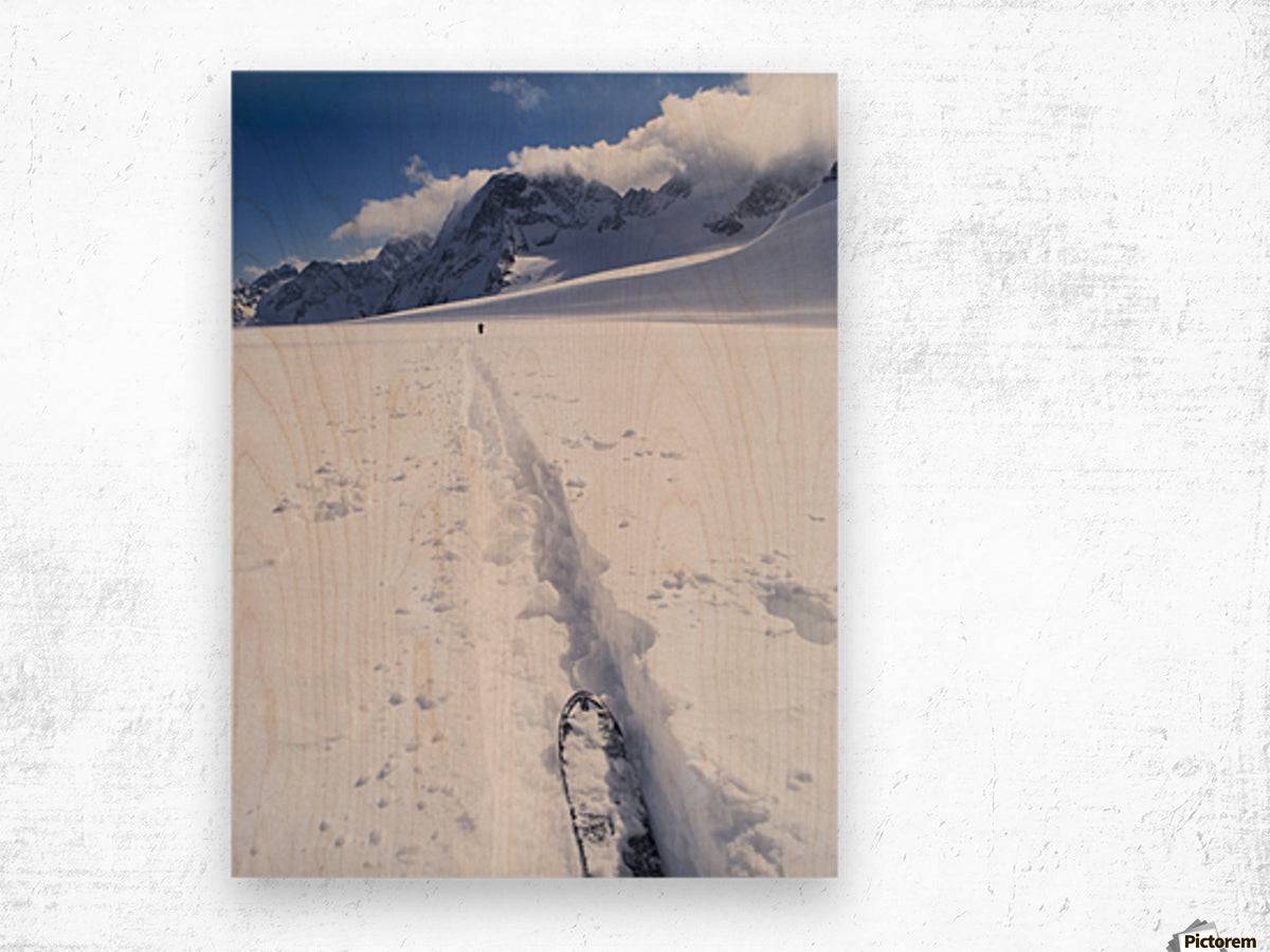 Two distant skiers ski touring across the Ottemma glacier, with skinning tracks - Powderaddicts