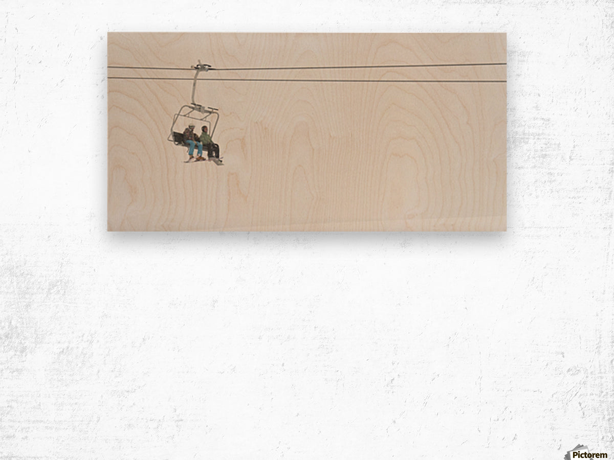 Two People Riding A Chairlift At A Ski Resort - Powderaddicts