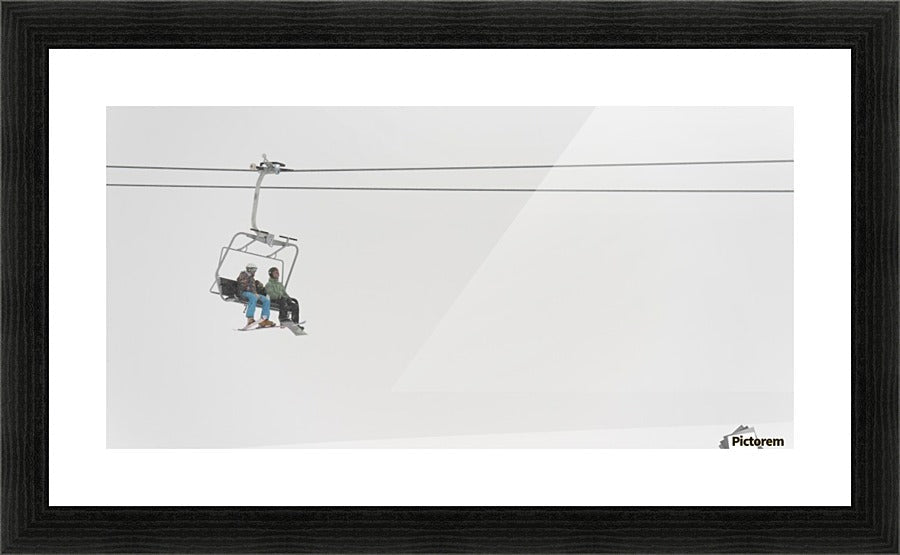 Two People Riding A Chairlift At A Ski Resort - Powderaddicts