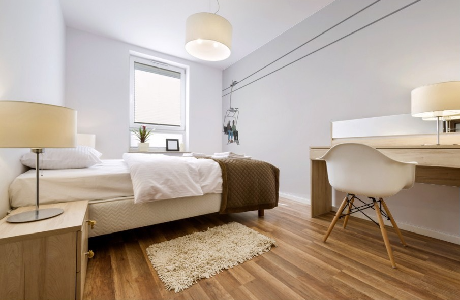 Two People Riding A Chairlift At A Ski Resort - Powderaddicts