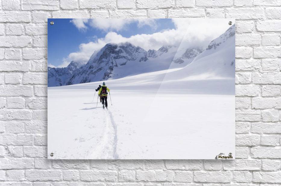 Two skiers ski touring across the Ottemma glacier - Powderaddicts