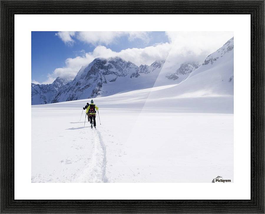 Two skiers ski touring across the Ottemma glacier - Powderaddicts