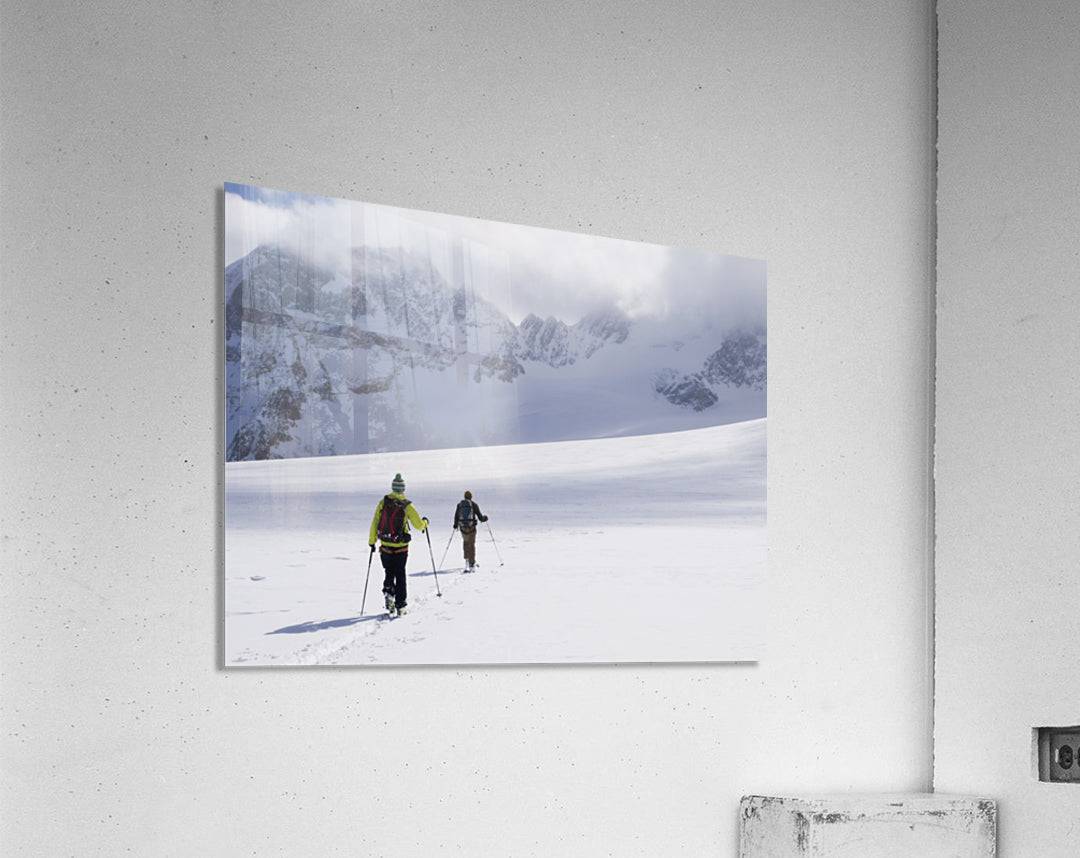 Two skiers ski touring across the Ottemma glacier - Powderaddicts