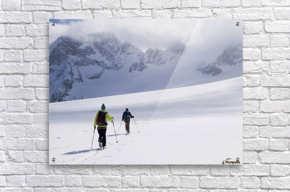 Two skiers ski touring across the Ottemma glacier - Powderaddicts