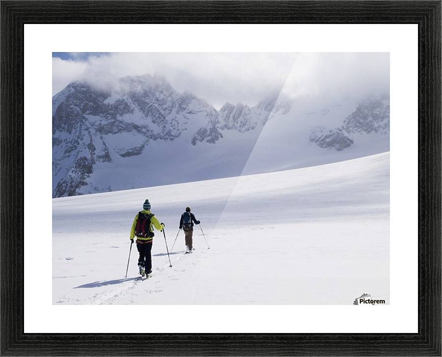 Two skiers ski touring across the Ottemma glacier - Powderaddicts